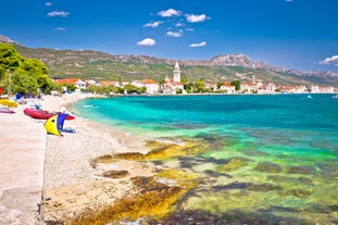 Photo of panorama and landscape of Makarska resort and its harbour with boats and blue sea water, Croatia.