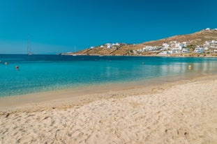 Photo of panoramic aerial view of the popular Platis Gialos beach on the Greek island of Mykonos with turquoise sea, Greece.