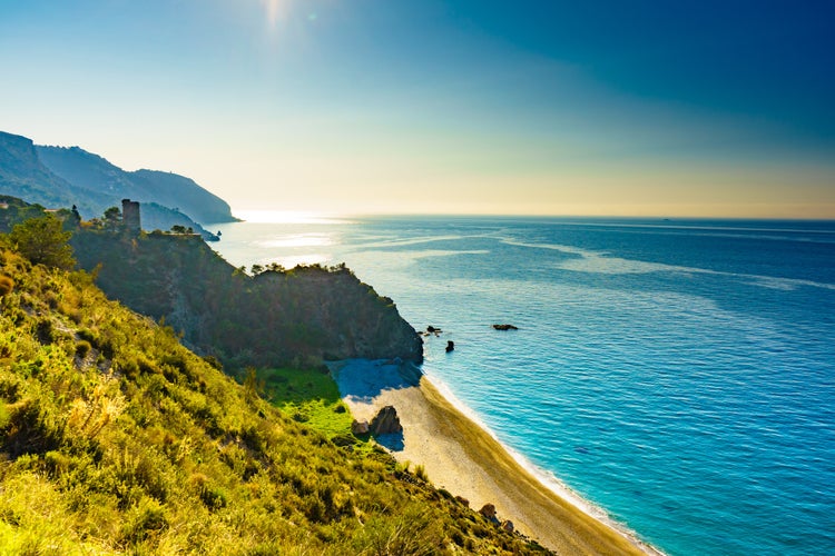 photo of view of Coast view with watchtower. Torre Del Pino, Pine tower on cliffs of Maro Cerro Gordo Natural Park, Malaga province, Costa Del Sol, Andalusia, Spain.