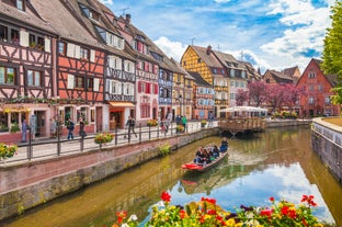 Photo of traditional half-timbered houses on picturesque canals in La Petite France in the medieval fairytale town of Strasbourg, France.