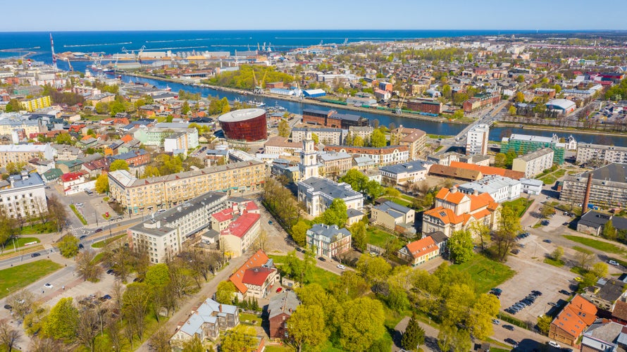 photo of view of Liepaja,Latvia,Baltics.Beautiful panoramic aerial view photo from flying drone to Holy Trinity Cathedral,Concert hall Great Amber (Lielais dzintars) and city center, trade channel in spring. (Series)