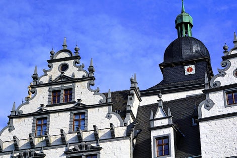 photo  of view of The historical building. The castle in the city of Wolfsburg. Germany. against the blue sky. calaxery and clock.