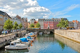 Scenic summer view of Nyhavn pier with color buildings, ships, yachts and other boats in the Old Town of Copenhagen, Denmark