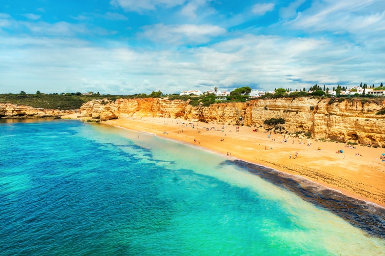 Photo of beautiful sandy beach surrounded with cliffs called Praia Nova, Porches, Algarve, Portugal.