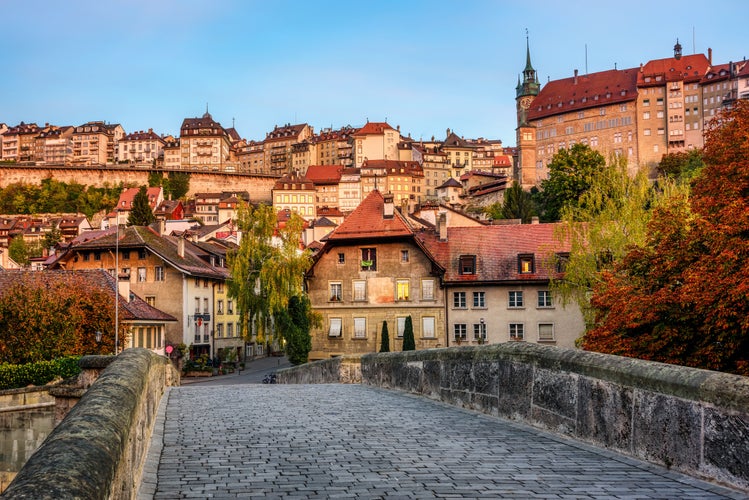 Photo of historical old town of Fribourg city in the golden sunrise light, Switzerland.