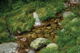 photo of Poço da Broca waterfall in Serra da Estrela Natural Park, Barriosa, municipality of Seia in Portugal, with a viewpoint in the foreground, at the end of a spring day.