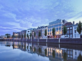 Amsterdam Netherlands dancing houses over river Amstel landmark in old european city spring landscape.