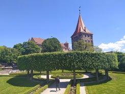 Photo of scenic summer view of the German traditional medieval half-timbered Old Town architecture and bridge over Pegnitz river in Nuremberg, Germany.