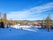 photo of skiers on a ski slope leading to the ski lift at Järvsöbacken ski resort in Järvso, Sweden.