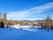 photo of skiers on a ski slope leading to the ski lift at Järvsöbacken ski resort in Järvso, Sweden.