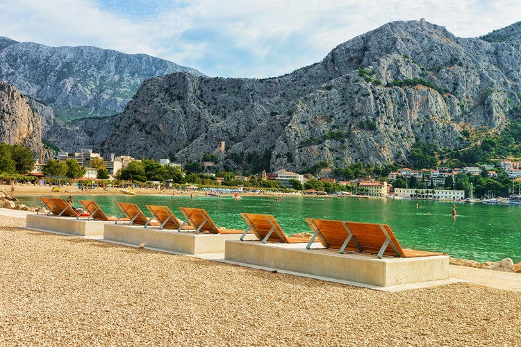 Photo of sunbeds on the beach in Omis, Croatia.