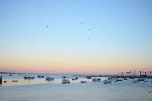 Photo of aerial view over People Crowd Having Fun On Beach And Over Cascais City In Portugal.