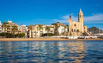 Photo of Sand beach and historical Old Town in mediterranean resort Sitges near Barcelona, Costa Dorada, Catalonia, Spain.