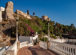 photo of Almuñécar, Spain - A scenic view of a coastal city with white buildings and a blue ocean in the background.