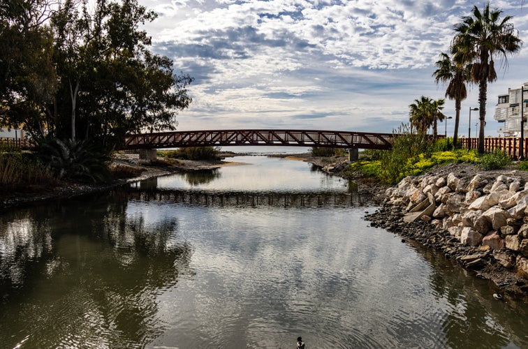 Photo of Bridge and Reflections of clouds in the water, San Pedro de Alcántara, Marbella, Spain