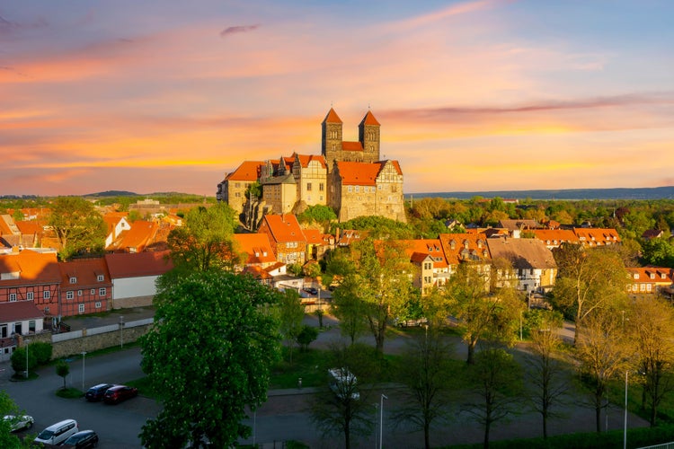 photo of view of Quedlinburg Castle over old town at sunset, Germany.