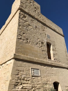Stone watch tower fortification in St Julian’s Malta, erected in 1658 by grandmaster FR Martin De Redin the tower has been subtly renovated over the years which can be seen in the stone work