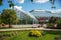 photo of purple lilac bushes and small trees and greenhouse on Bergian botanic garden and amazing sunny day in Stockholm, Sweden.