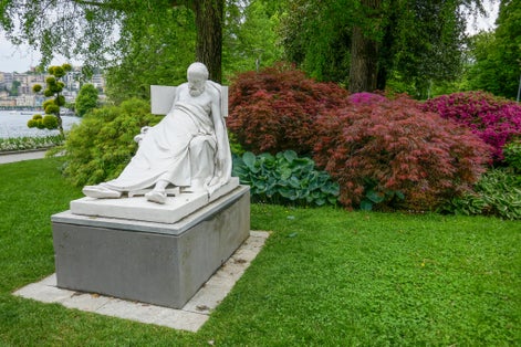 Photo of White stone sculpture of the dying Greek philosopher Socrates, dating from 1876 AD, in the Parco Ciani (Ciani Park) in the city of Lugano, Ticino, Switzerland.