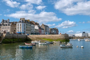 Photo of Vannes, beautiful city in Brittany, boats in the harbor, with typical houses and the cathedral in background, France.