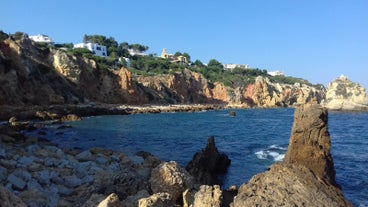 Photo of wide sandy beach in white city of Albufeira, Algarve, Portugal.