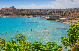 Photo of aerial view of Otranto town in Puglia with crystal turquoise waters, Italy.