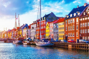 Scenic summer view of Nyhavn pier with color buildings, ships, yachts and other boats in the Old Town of Copenhagen, Denmark