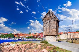 Photo of Saint Anastasia Island in Burgas bay, Black Sea, Bulgaria. Lighthouse tower and old wooden buildings on rocky coast.