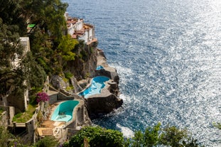 Photo of aerial morning view of Amalfi cityscape on coast line of Mediterranean sea, Italy.