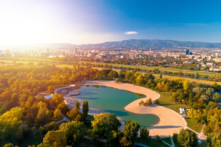 Photo of Bundek lake and city of Zagreb aerial autumn sun haze view.