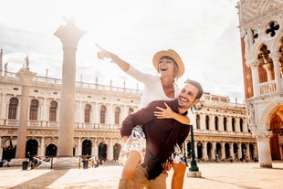 Famous buildings, gondolas and monuments by the Rialto Bridge of Venice on the Grand Canal, Italy.