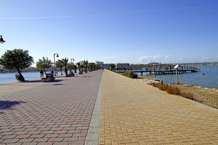 Photo of Beach seashore with wooden path to sea water in San Pedro del Pinatar