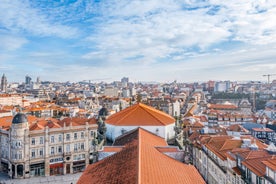 Porto, Portugal old town ribeira aerial promenade view with colorful houses, Douro river and boats.