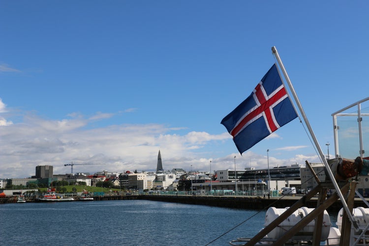 View on city Reykjavik in Iceland from boat with Iceland flag.jpg