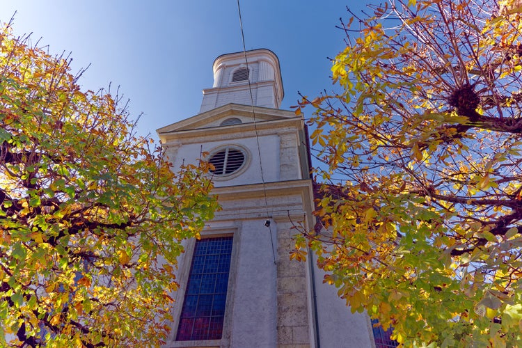 Photo of white catholic church at the old town of Olten, Canton Solothurn, in bright sunlight on a sunny autumn day ,Switzerland.