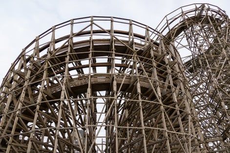 photo of Balder roller coaster structure with wooden beams rising high into the sky on Liseberg amusement park in Gothenburg, Sweden.