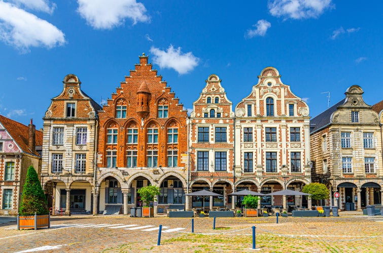 Flemish-Baroque-style townhouses buildings on La Grand Place square in Arras historical city center, blue sky in summer day, Artois, Pas-de-Calais department, Hauts-de-France Region, Northern France