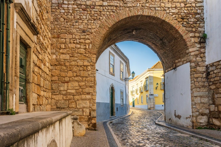 Photo of resting Arch in medieval walls is one of 4 entrances to the old town in Faro, Algarve, Portugal.