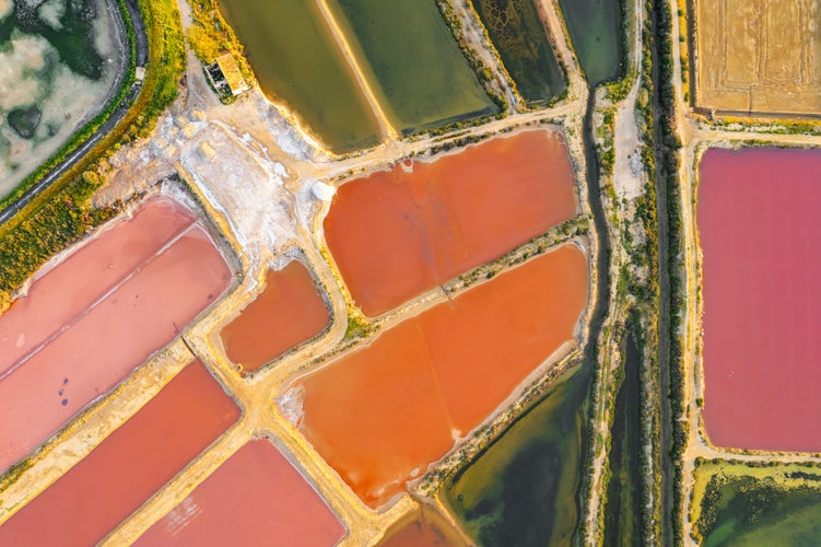 Photo of Top down view of the colorful salt ponds near Olhao town, Southern Portugal. Saline marshes on the Ria Formosa lagoon in Tavira, Algarve, Portugal. Salt production in Algarve region.