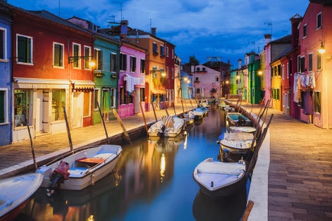 photo of view of Colourfully painted houses facade on Burano island in evening, province of Venice, Italy.