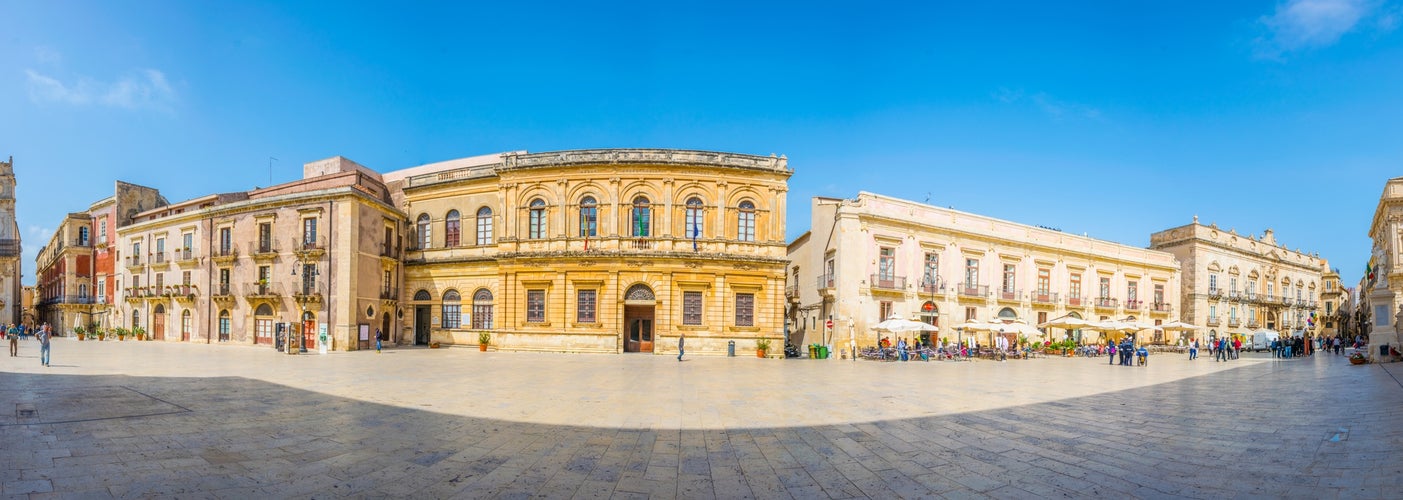 People are strolling on piazza Duomo in Syracuse, Sicily, Italy