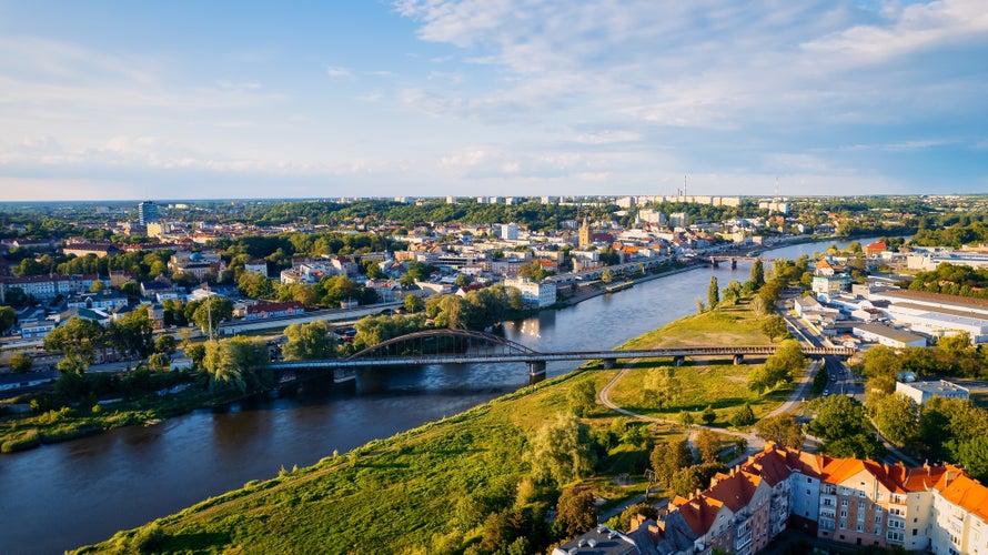 In Gorzów Wielkopolski, a drone photo was taken on a sunny day featuring the River Warta, the Cathedral, and the city center