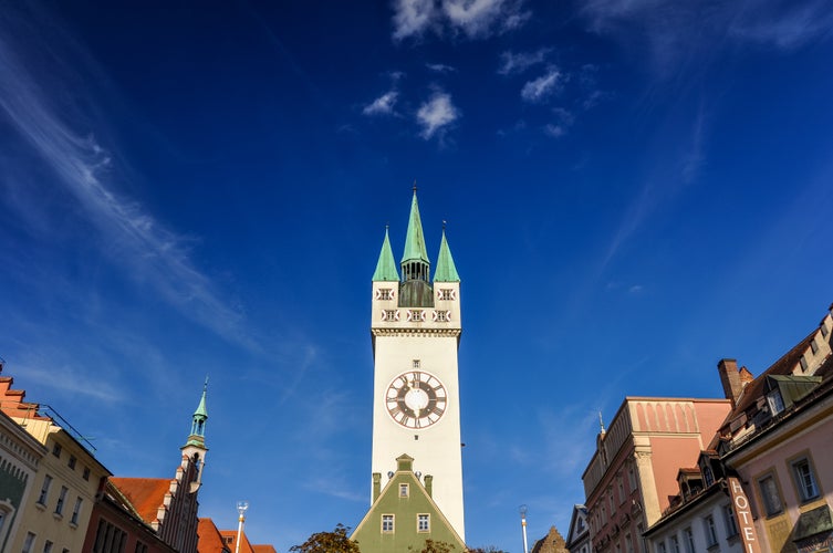 Historic city center of Straubing with old City Tower on a sunny afternoon. Straubing is a city in Lower Bavaria, Bavaria, Germany. The tower, called Stadtturm, is the historic center of the city.