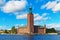 photo of scenic summer view of the Stockholm City Hall in the Old Town (Gamla Stan) in Stockholm, Sweden.