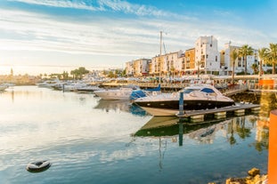 Photo of wide sandy beach in white city of Albufeira, Algarve, Portugal.