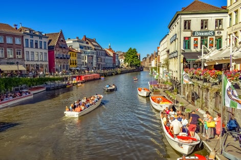 Photo of Row of historic buildings along the tourist boats floating on the river, Ghent, Belgium