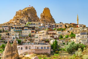 Hot air balloons flying over Uchisar Castle. Cappadocia. Nevsehir Province. Turkey.