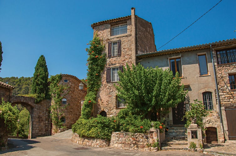 photo of view of View of old stone houses in alley under blue sky, at the gorgeous medieval hamlet of Les Arcs-sur-Argens, near Draguignan. Located in the Provence region, Var department, southeastern France