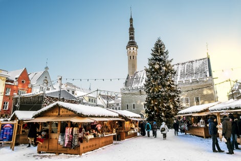 Photo of the Christmas market on town hall square in Tallinn in winter, Estonia.