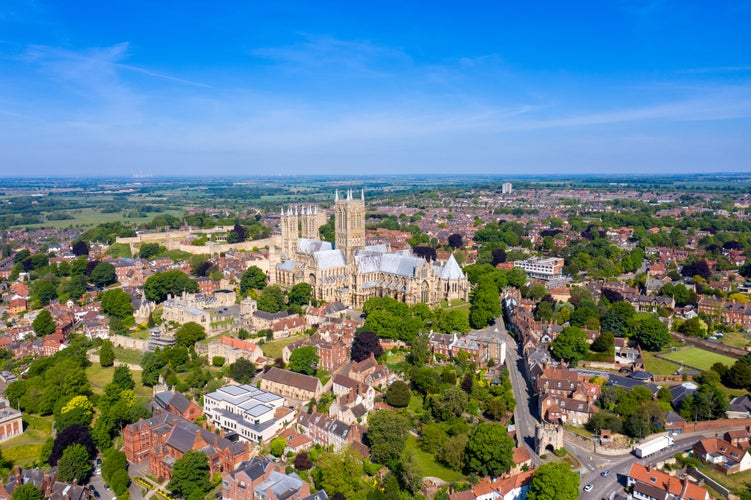 Aerial photo of the city centre of Lincoln and Lincoln Cathedral, Lincoln Minster in the city centre of Lincoln on a bright sunny summers day showing the historic Cathedral Church in the city centre